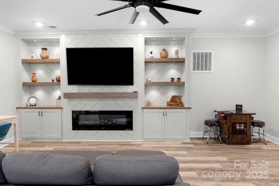 2nd floor bonus/loft are with custom shelving and electric fireplace