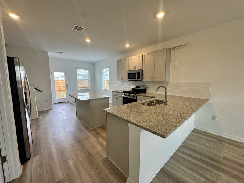 Furnished interior view inside a new home in Longview 40s - Alley, Del Valle (Image 5).