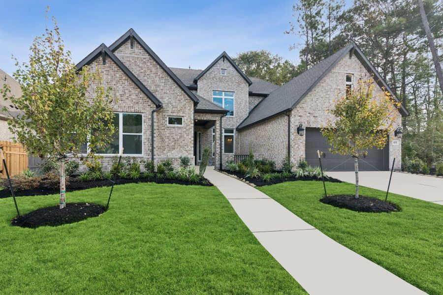 Front exterior of a new home in ARTAVIA 65' Homesites, Conroe, TX, highlighting curb appeal (Image 22).
