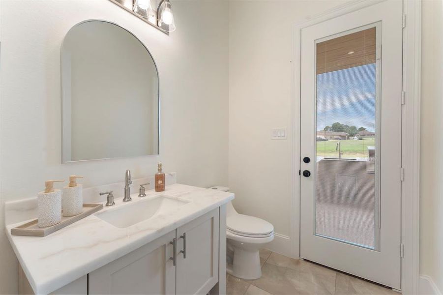 Guest powder room with access to your patio making it a perfect future pool bath.