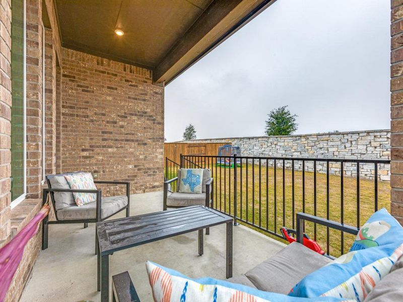 Out back, you’ve got no rear neighbors and a covered, raised patio with wrought iron railings.