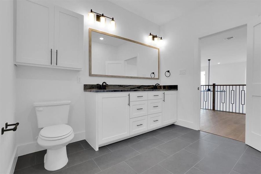 Full bath with double vanity and tile patterned floors Full bath with double vanity and tile patterned floors