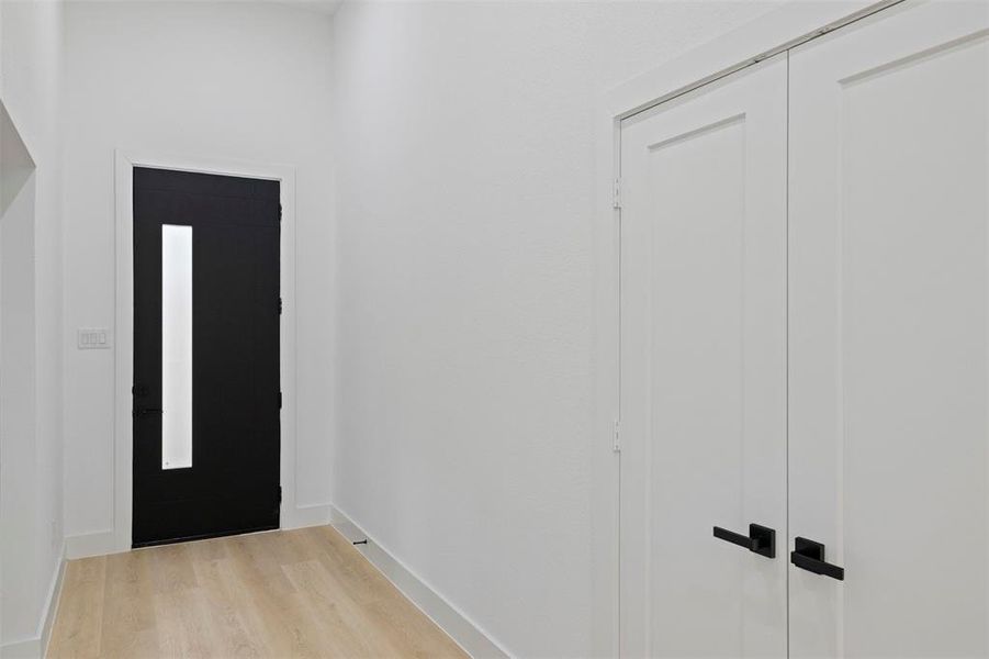 Entryway featuring light wood-style flooring and baseboards