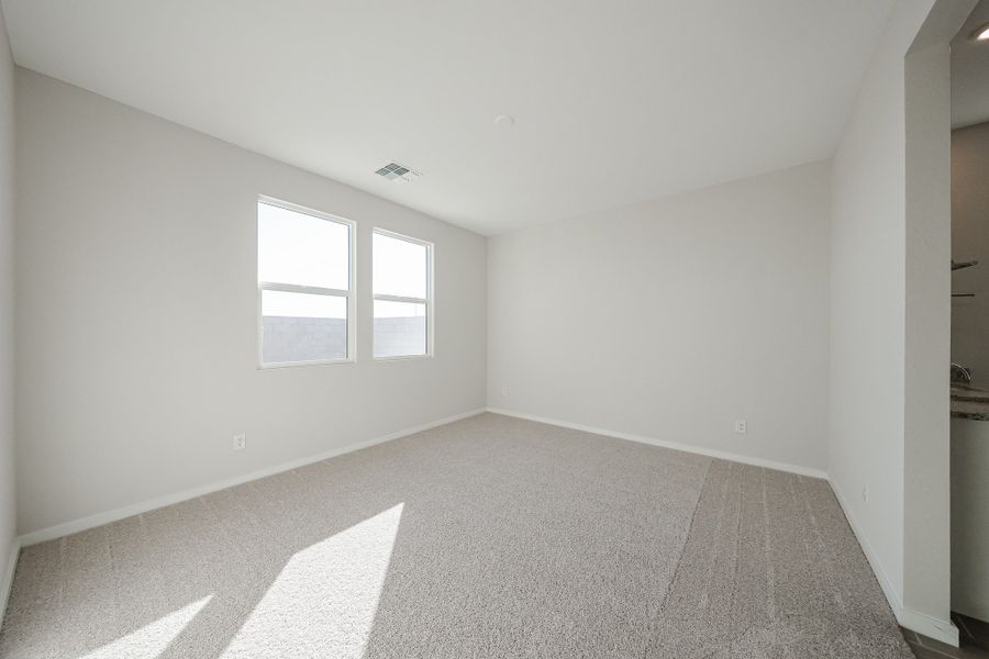 A room with a carpet and windows. A room with a carpet and windows.