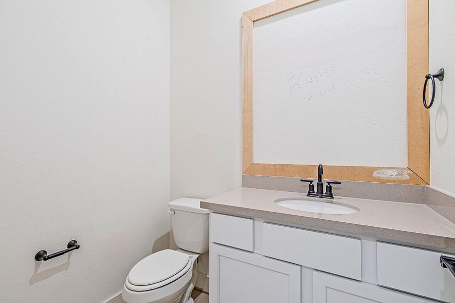 Powder bath with stylish vanity and modern fixture