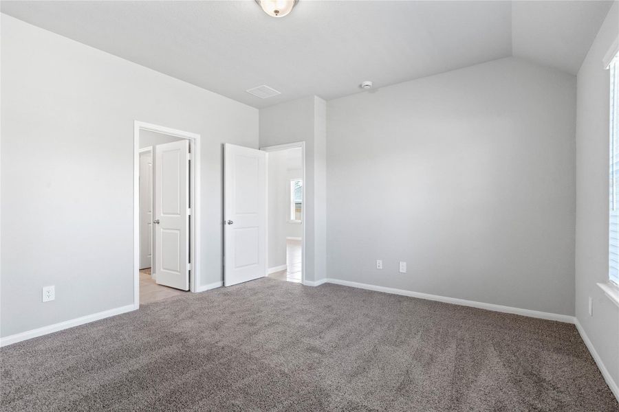 The private primary suite efficiently connects the sleeping area with the dedicated bathroom and generous closet.