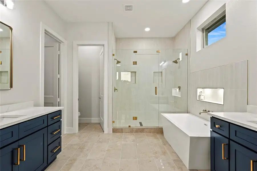 Bathroom with vanity, a shower stall, a freestanding bath, and recessed lighting Bathroom with vanity, a shower stall, a freestanding bath, and recessed lighting