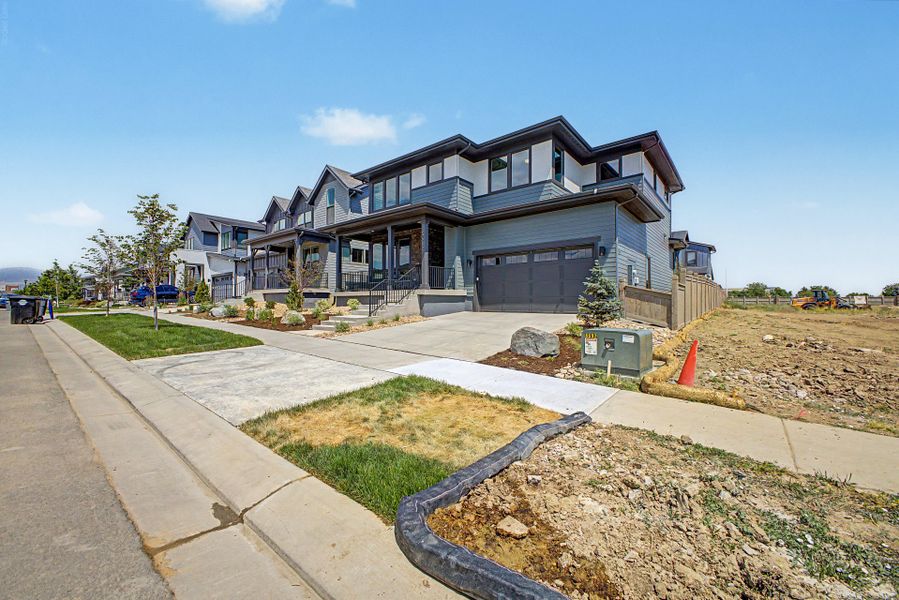 Front exterior of a new home in West Grange, Longmont, CO, highlighting curb appeal (Image 16). Front exterior of a new home in West Grange, Longmont, CO, highlighting curb appeal (Image 16).
