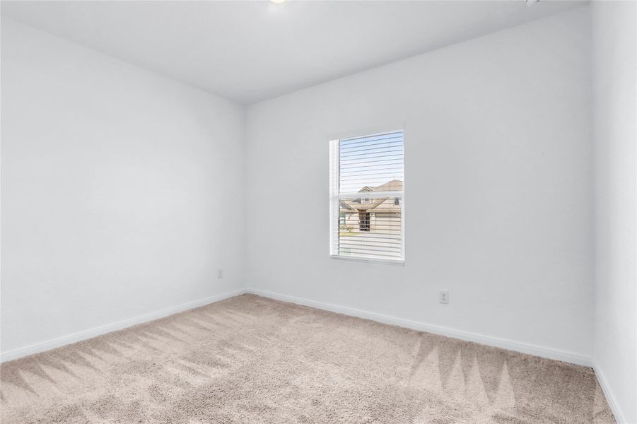 Empty room with carpet and baseboards