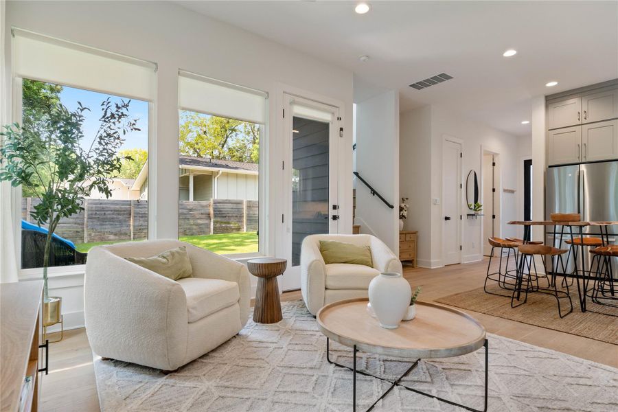 Hardwood floors and massive windows frame views of the private backyard in this open floorplan.