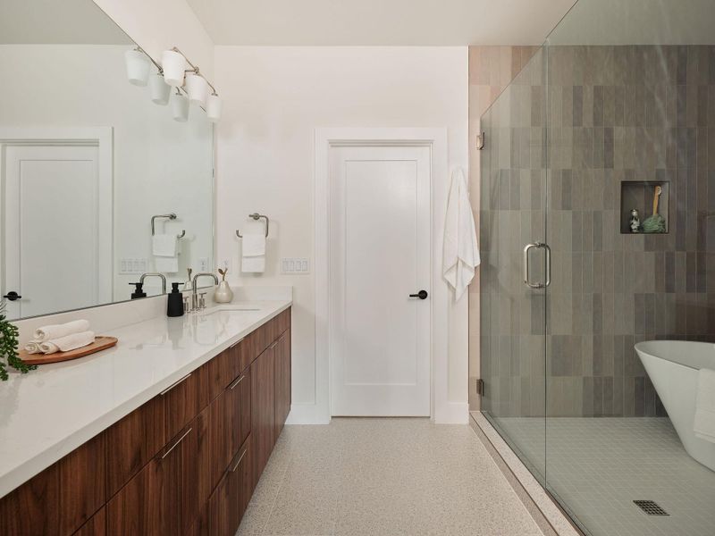 Bathroom featuring vanity, a stall shower, and a freestanding bath Bathroom featuring vanity, a stall shower, and a freestanding bath