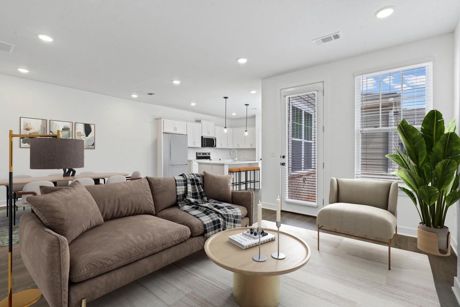 Open-concept living area with recessed lighting and wood-finish flooring