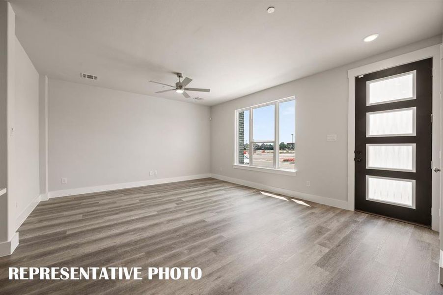 This spacious, light filled family room is the perfect place to host friends and family!  REPRESENTATIVE PHOTO