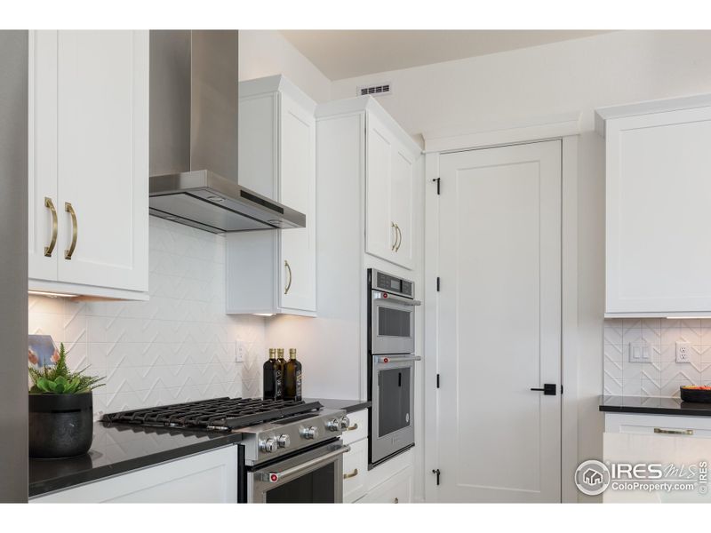 Kitchen with Double Ovens, Vented Hood Range, and Microwave Oven. Kitchen with Double Ovens, Vented Hood Range, and Microwave Oven.