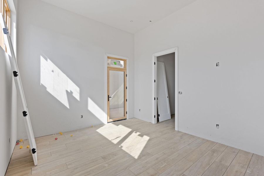 Sun-filled room boasts high ceilings and newly installed light-toned hardwood flooring. Sun-filled room boasts high ceilings and newly installed light-toned hardwood flooring.
