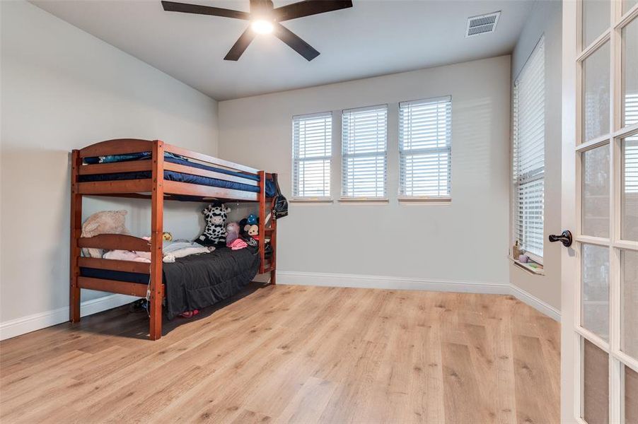 Bedroom with wood finished floors and ceiling fan Bedroom with wood finished floors and ceiling fan