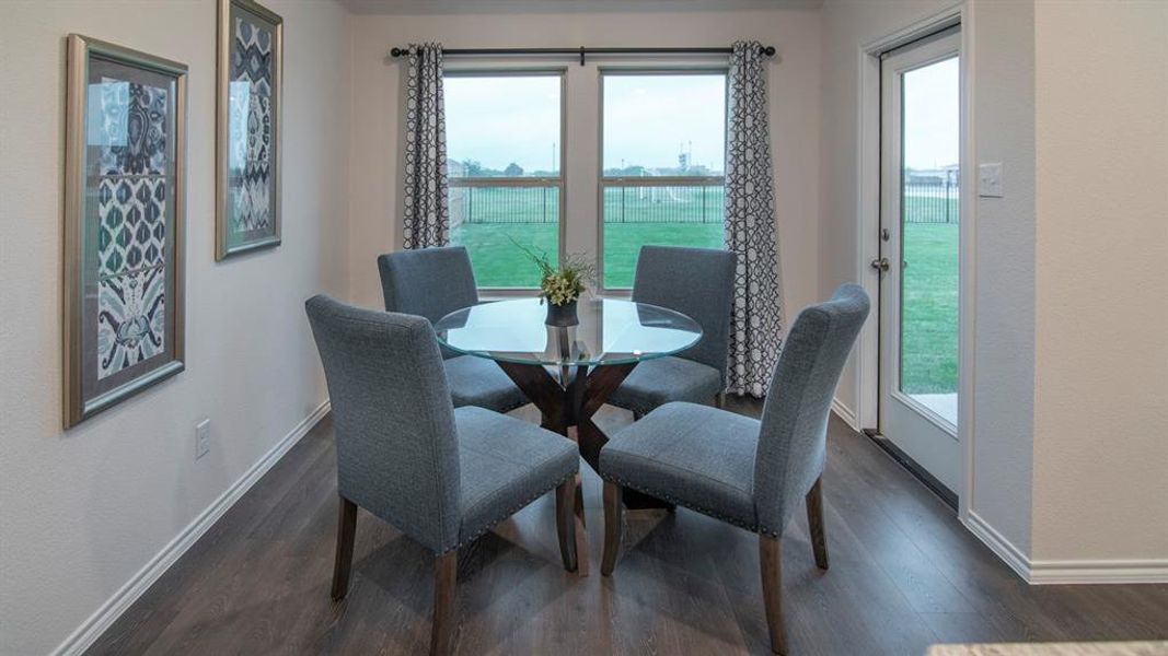 Dining space featuring dark wood-type flooring and a water view