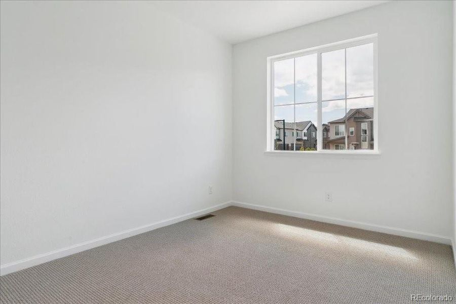 Spacious, unfurnished interior of a new home in Pacific Collection at The Townes at Skyline Ridge, Castle Pines (Image 10).