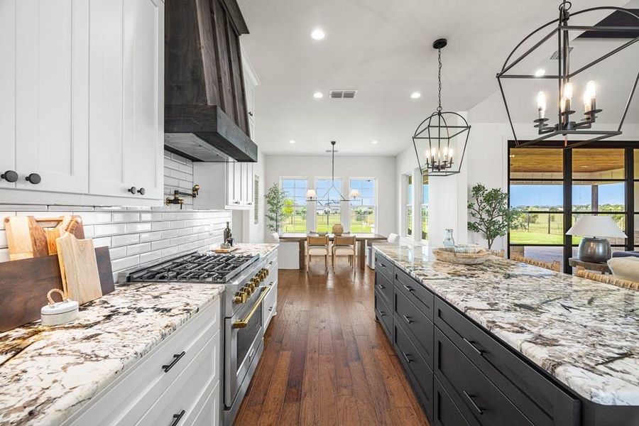 Kitchen featuring 6 burner gas range, white cabinets and stone countertops Kitchen featuring 6 burner gas range, white cabinets and stone countertops