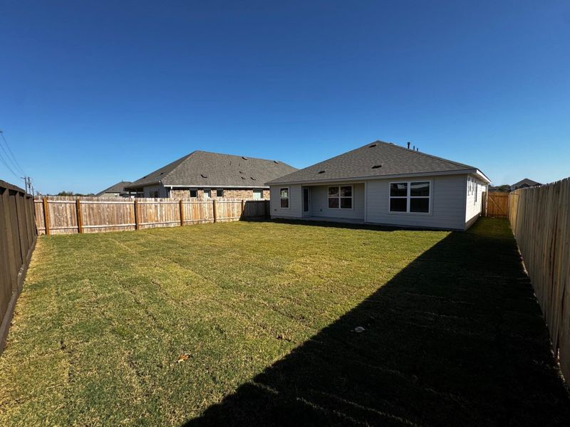 Back of property featuring a fenced backyard and a patio area Back of property featuring a fenced backyard and a patio area