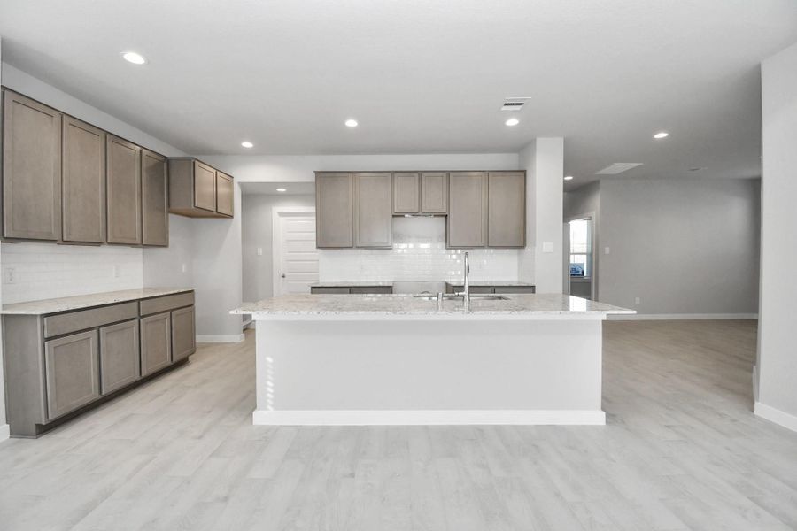 This generously spacious kitchen is a dream realized! Sample photo of completed home with similar floor plan. Actual colors and selections may vary.