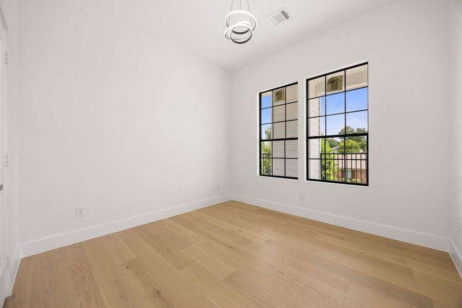 Primary suite 1 features two front facing windows that fill the room with natural lighting along with convenient access to a private en-suite bath.