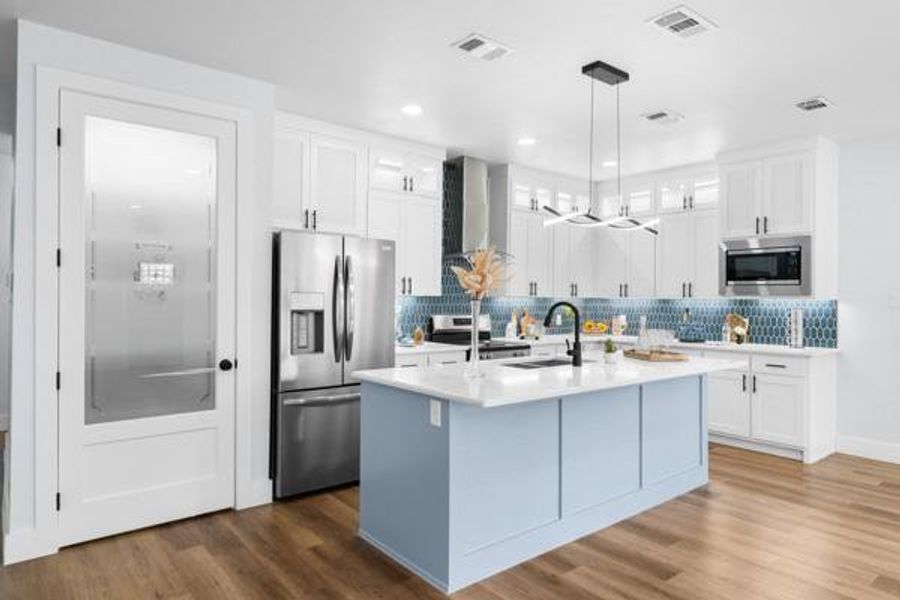 Kitchen with glass insert cabinets, white cabinetry, decorative backsplash, and recessed lighting Kitchen with glass insert cabinets, white cabinetry, decorative backsplash, and recessed lighting