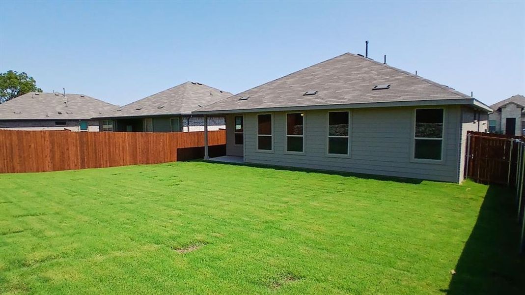 Front exterior of a new home in The Canyons, Keene, TX, highlighting curb appeal (Image 1).