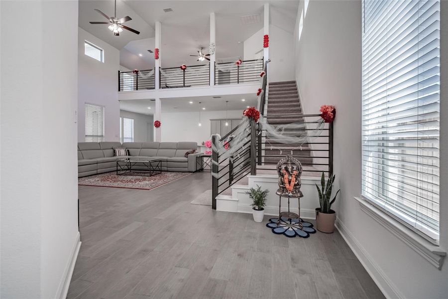 Two-story volume ceiling and open-concept design highlight this generously proportioned living space.