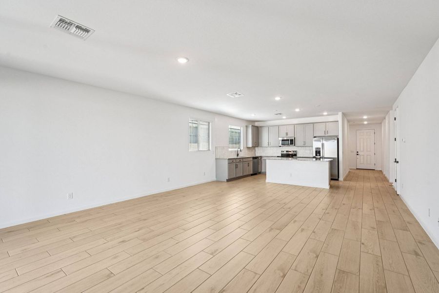 Great room, dining and kitchen. Finishes may vary by community.