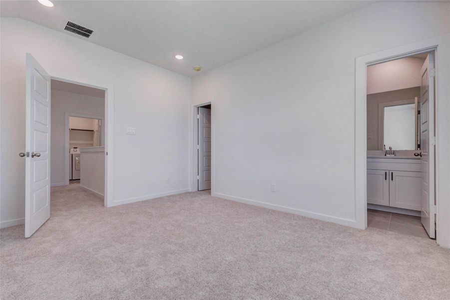 Secondary bedroom with soft carpet, recessed lighting, neutral walls, and direct access to a private or nearby bath area. Multiple doorways provide convenient flow to the hall, closet, and bathroom, making this room a flexible and comfortable space for guests, family members, or a private upstairs retreat. Secondary bedroom with soft carpet, recessed lighting, neutral walls, and direct access to a private or nearby bath area. Multiple doorways provide convenient flow to the hall, closet, and bathroom, making this room a flexible and comfortable space for guests, family members, or a private upstairs retreat.