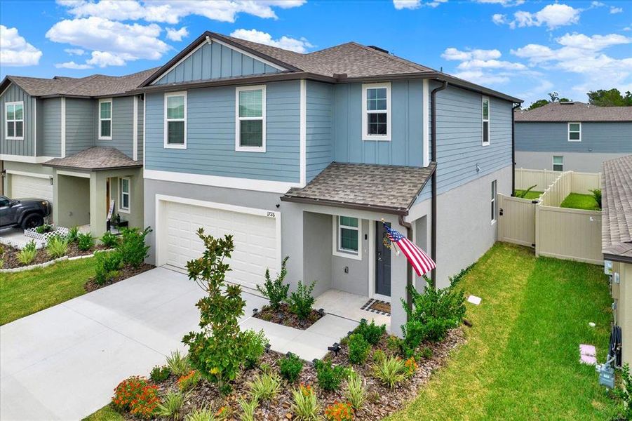 Front exterior of a new home in Two Rivers: The Manors II, Zephyrhills, FL, highlighting curb appeal (Image 20). Front exterior of a new home in Two Rivers: The Manors II, Zephyrhills, FL, highlighting curb appeal (Image 20).