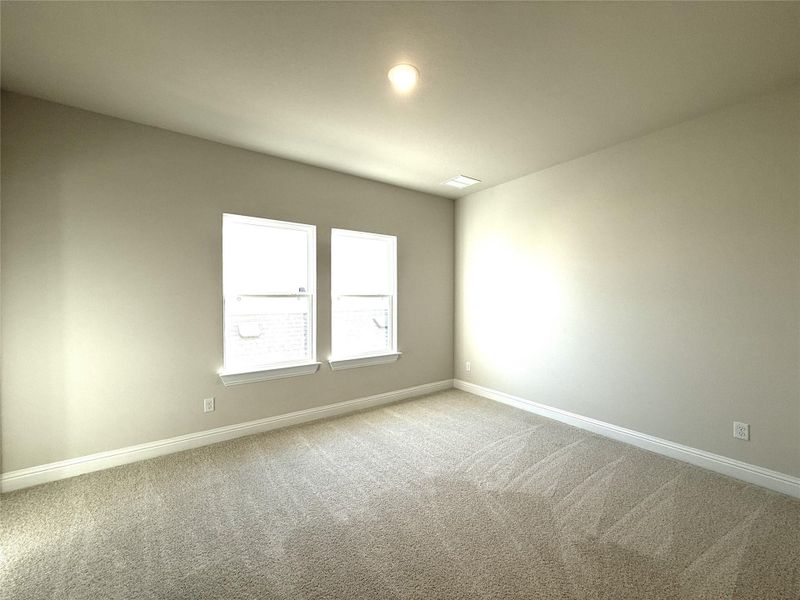 Spare room featuring baseboards and light carpet