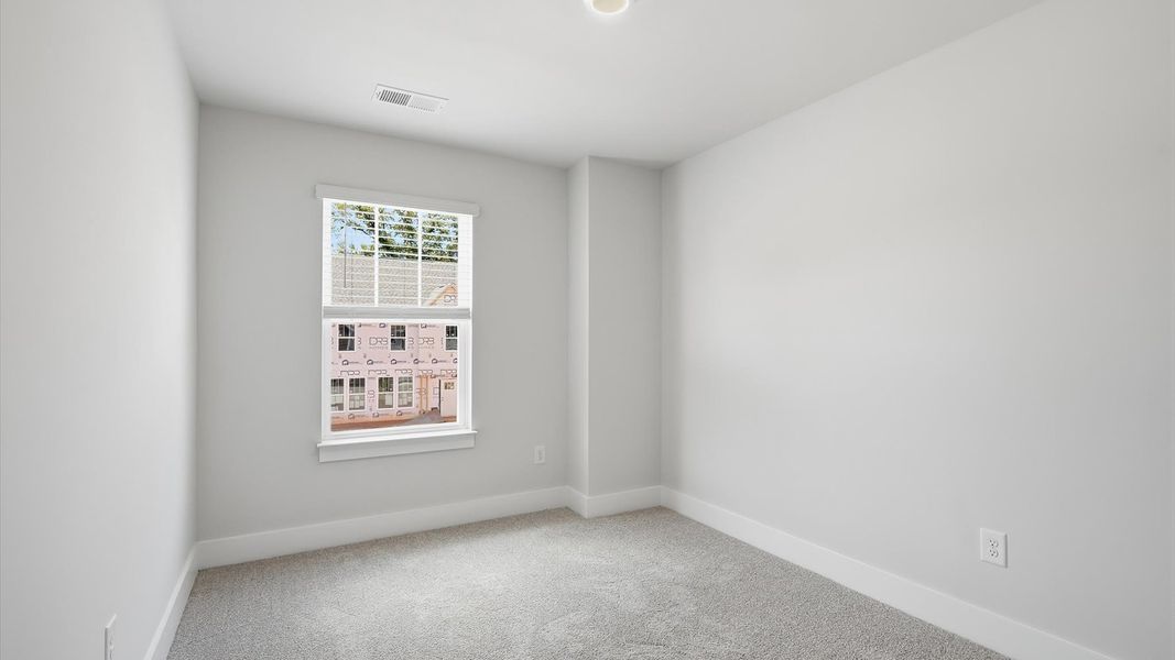 Superior comfort in this light-filled bedroom with plush carpeting and a thoughtfully placed large window Superior comfort in this light-filled bedroom with plush carpeting and a thoughtfully placed large window