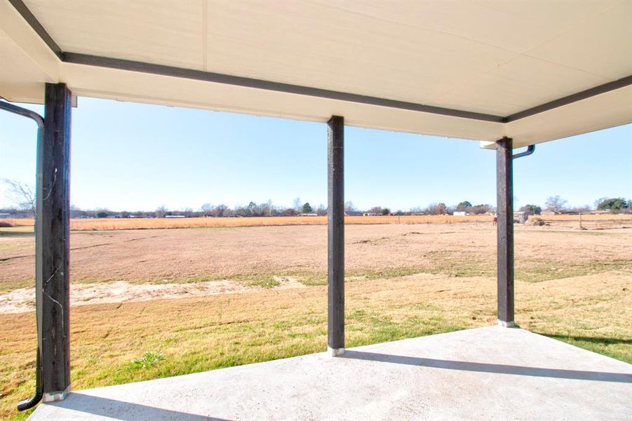View of  back patio with a rural view