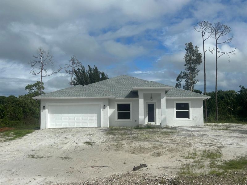 Front exterior of a new home in , The Acreage, FL, highlighting curb appeal (Image 2). Front exterior of a new home in , The Acreage, FL, highlighting curb appeal (Image 2).