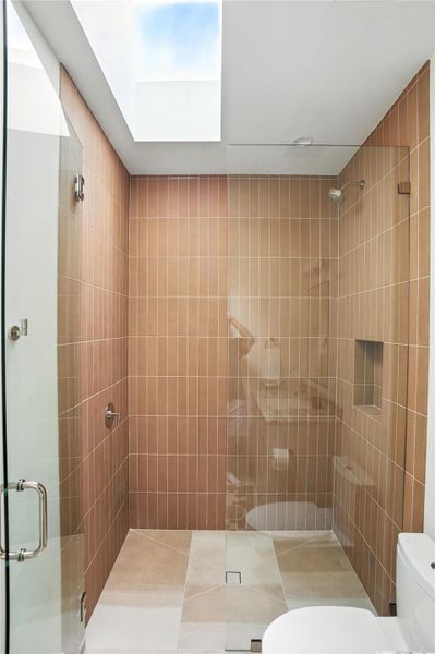 Full bathroom featuring a shower stall and tile patterned floors Full bathroom featuring a shower stall and tile patterned floors