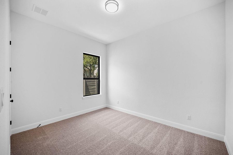 Unfurnished room with carpet and baseboards Unfurnished room with carpet and baseboards