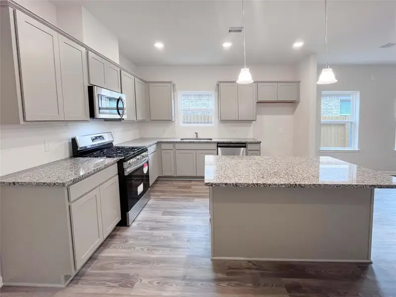 The Mockingbird II- Kitchen with center island. Sample photo used for illustrative purposes only, options/colors will vary.