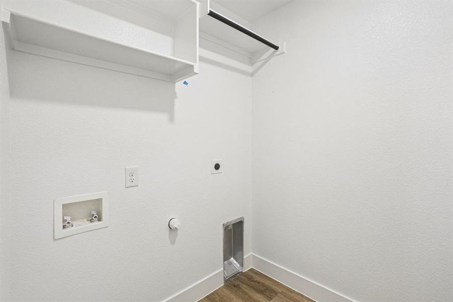 Washroom featuring dark wood-style flooring, electric dryer hookup, hookup for a gas dryer, and hookup for a washing machine Washroom featuring dark wood-style flooring, electric dryer hookup, hookup for a gas dryer, and hookup for a washing machine