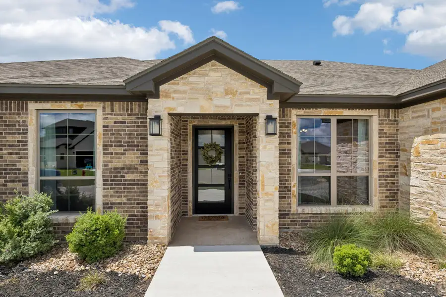 Some homes make a good first impression. Others make you curious about what's beyond the front door. This one does both.
