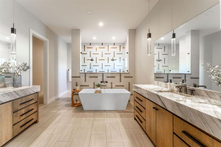 Bathroom featuring vanity and shower with separate bathtub