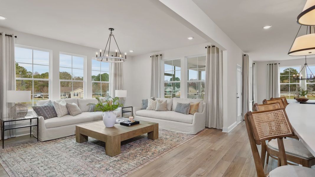 Stonefield home plan open concept family room with lots of windows Stonefield home plan open concept family room with lots of windows