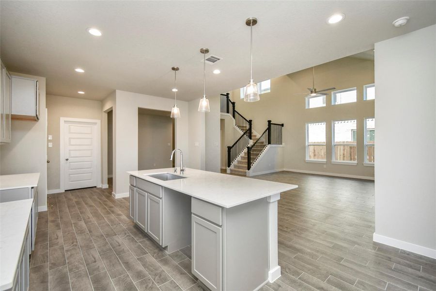 All of this overlooks your expansive family room, creating a perfect space forculinary delights and family gatherings. Sample photo of completed home with similar floor plan. Actual colors and selections may vary.