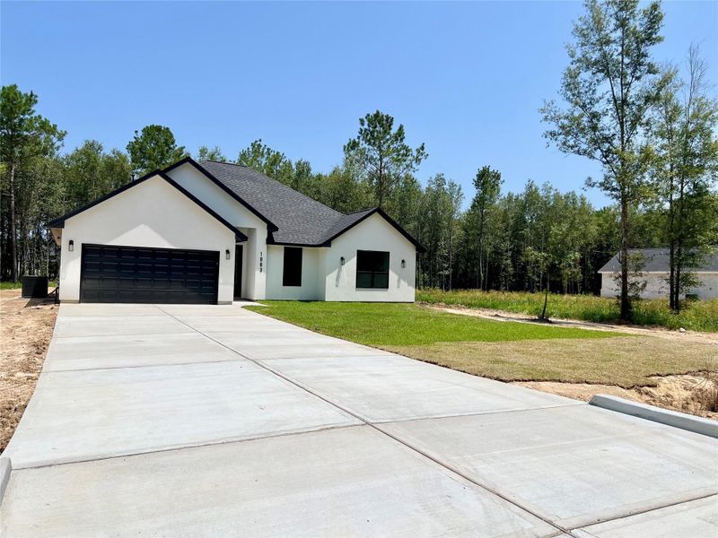Front exterior of a new home in , Dayton, TX, highlighting curb appeal (Image 22).