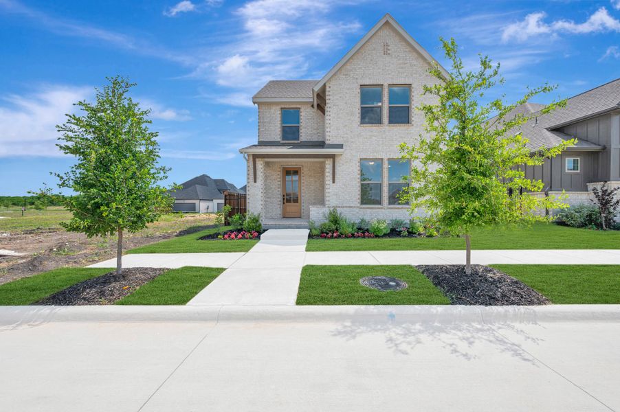 Front exterior of a new home in Talia – Cottage Series, Mesquite, TX, highlighting curb appeal (Image 1). Front exterior of a new home in Talia – Cottage Series, Mesquite, TX, highlighting curb appeal (Image 1).