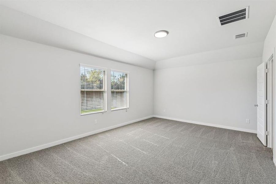 Primary Suite in the Oscar home plan by Trophy Signature Homes – REPRESENTATIVE PHOTO