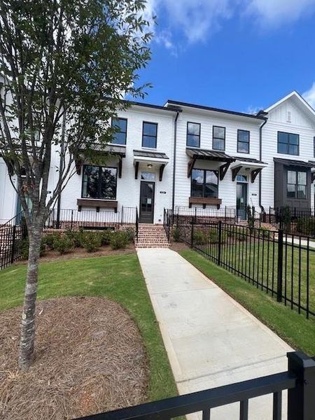 Front exterior of a new home in Palisades Townhomes, Cumming, GA, highlighting curb appeal (Image 2).