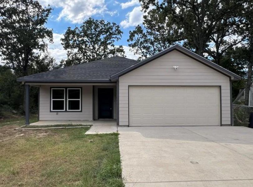 Single story home with concrete driveway, roof with shingles, a porch, a front lawn, and a garage