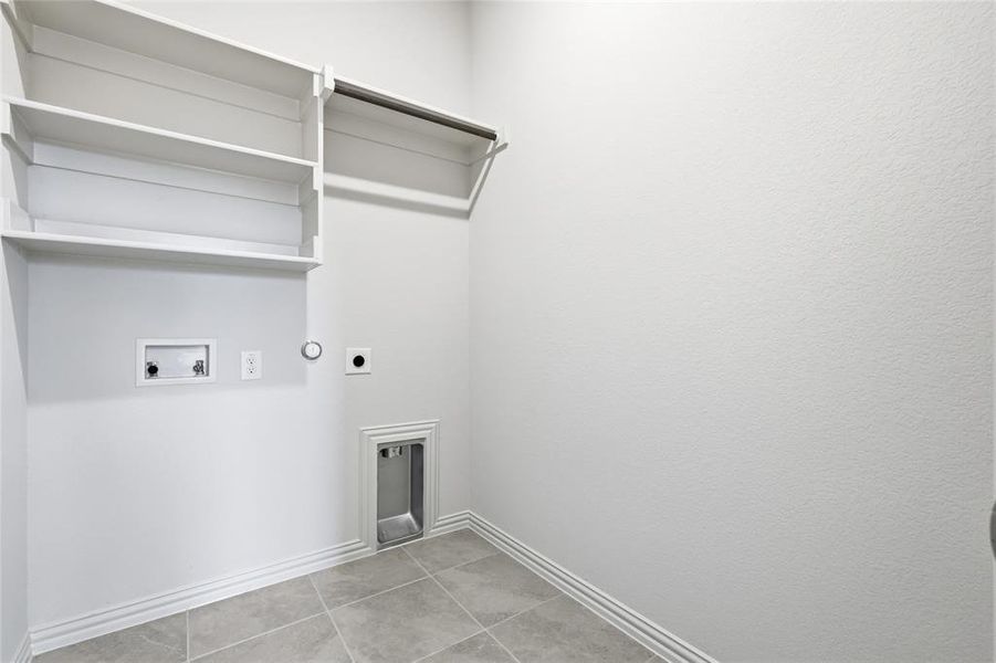 Washroom with hookup for a gas dryer, electric dryer hookup, washer hookup, and light tile patterned floors Washroom with hookup for a gas dryer, electric dryer hookup, washer hookup, and light tile patterned floors
